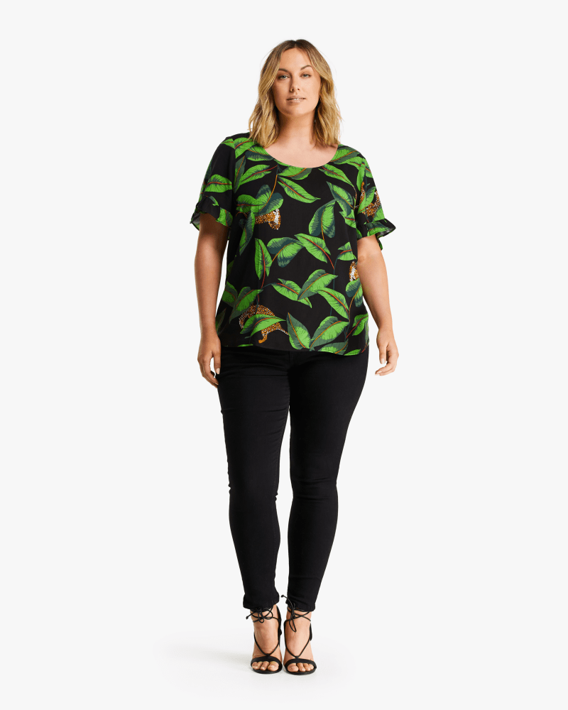 Front of a model wearing a size 1X Wild Jungle Top in Print by Estelle. | dia_product_style_image_id:235190